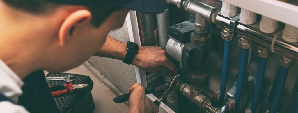 An HVAC Technician installing a heater.